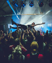 People at concert, man crowd diving