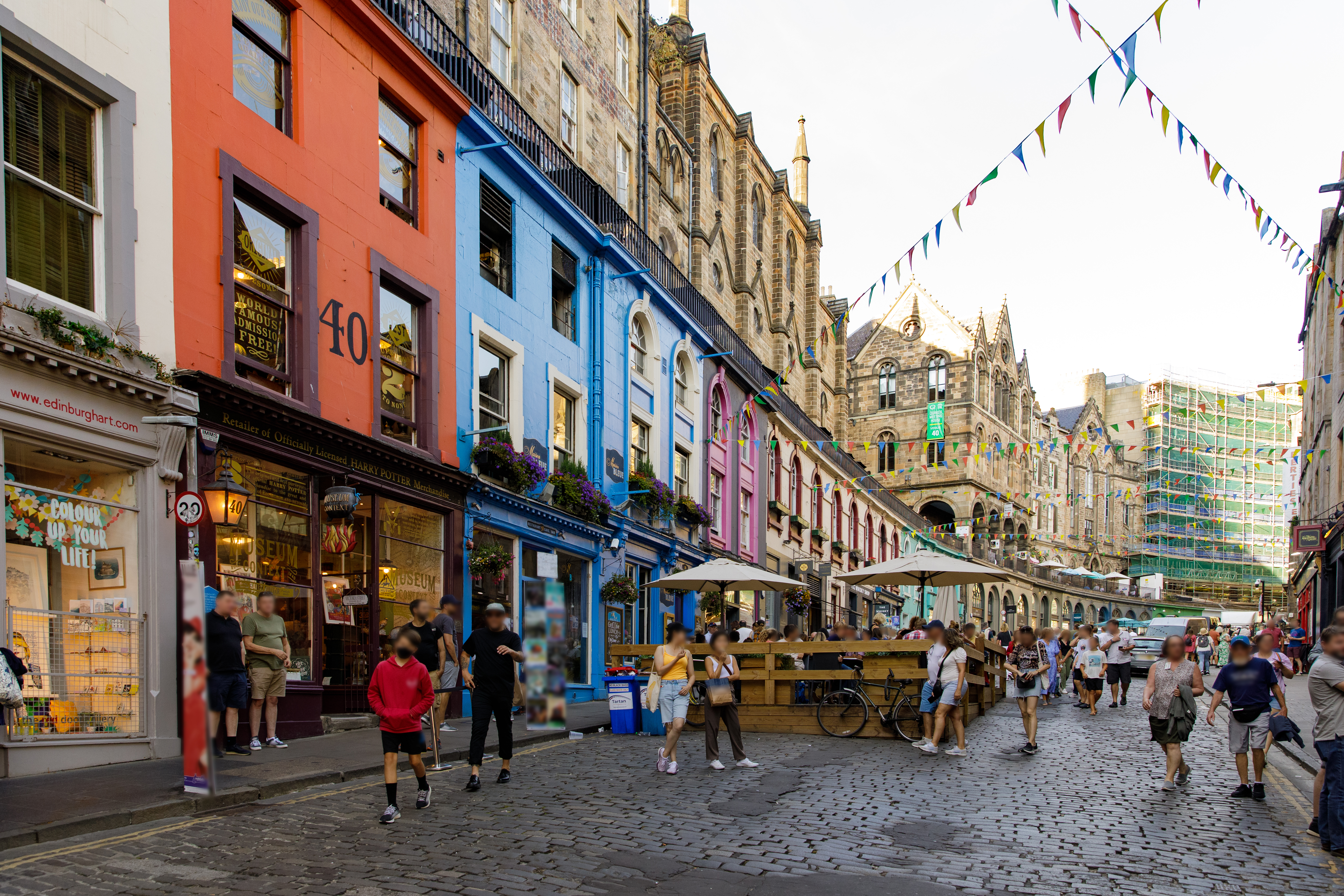 People walking in a street in a city lined with shops