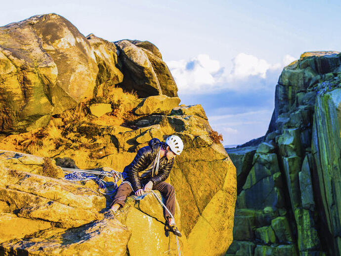 A rock climber considering a descent