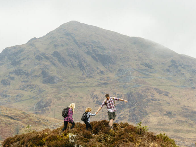 Man, woman and a child walking in the mountains