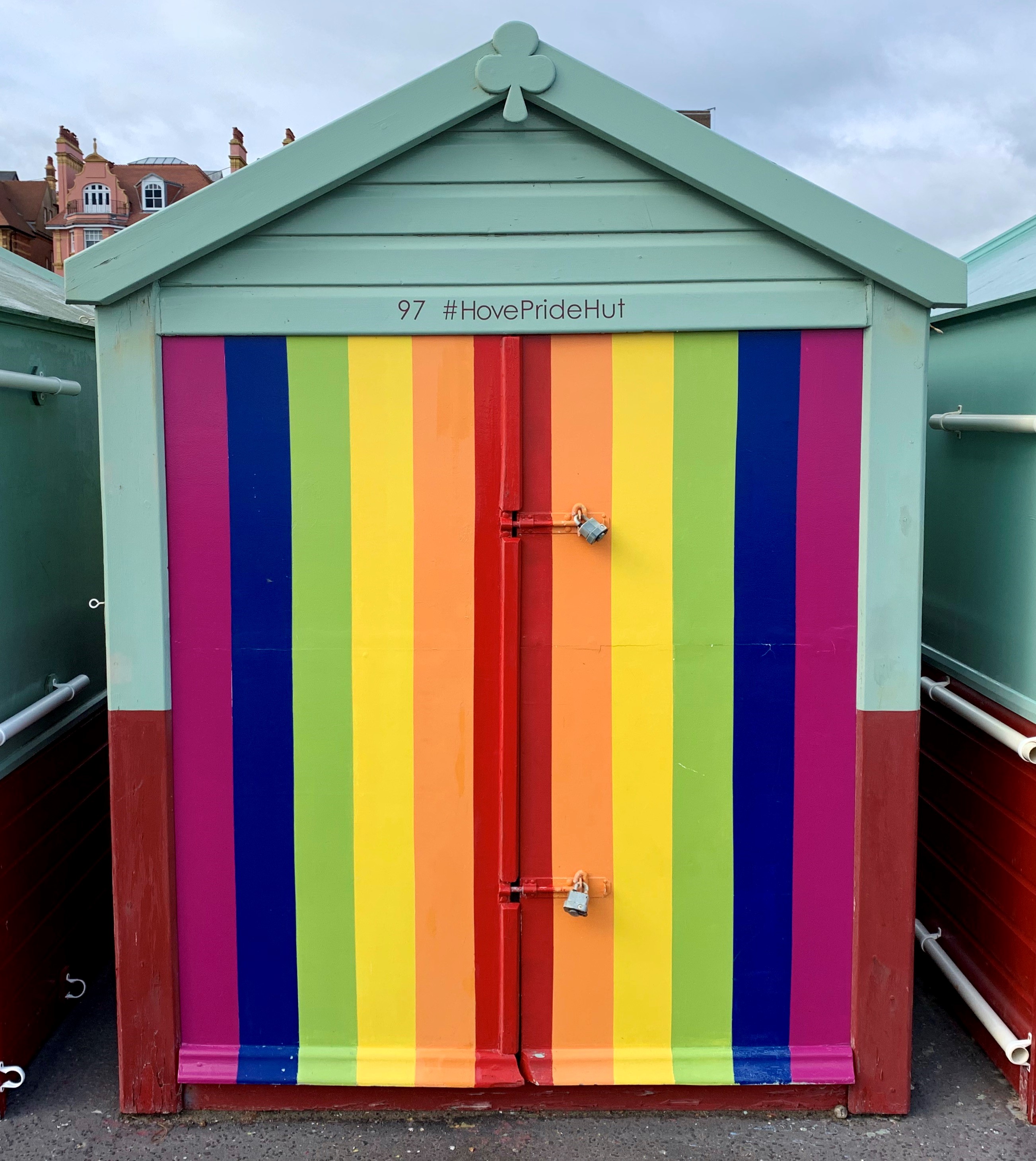 A rainbow coloured beach hut on Brighton and Hove beach