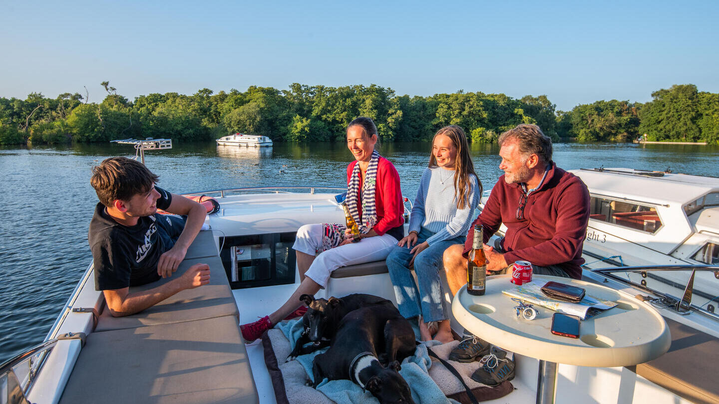 A family relaxing on a boat in the Broads