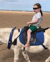 A child riding a donkey on Skegness Beach