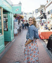 Woman walking down a pedestrian shopping street