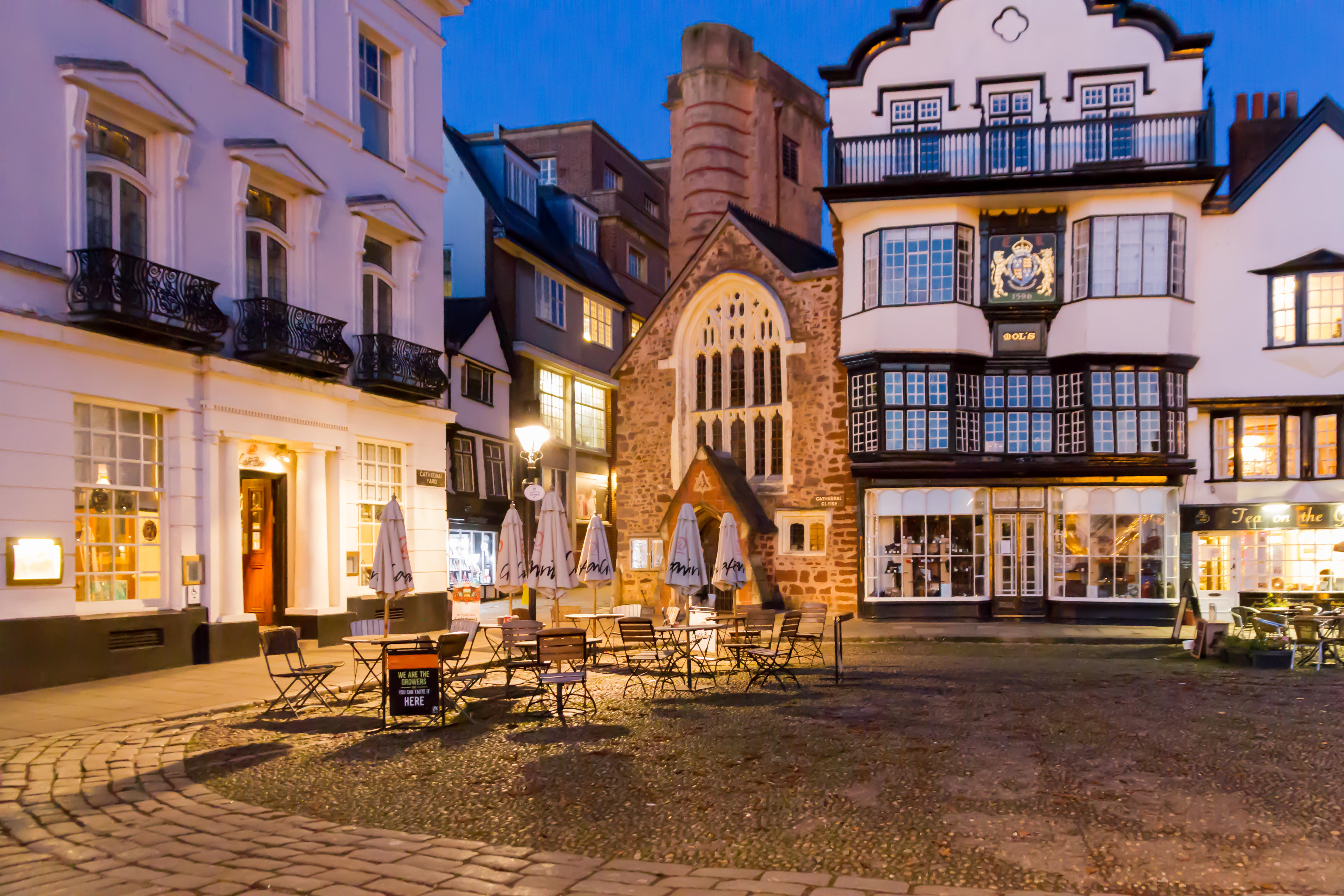 A quaint English town square in the evening.
