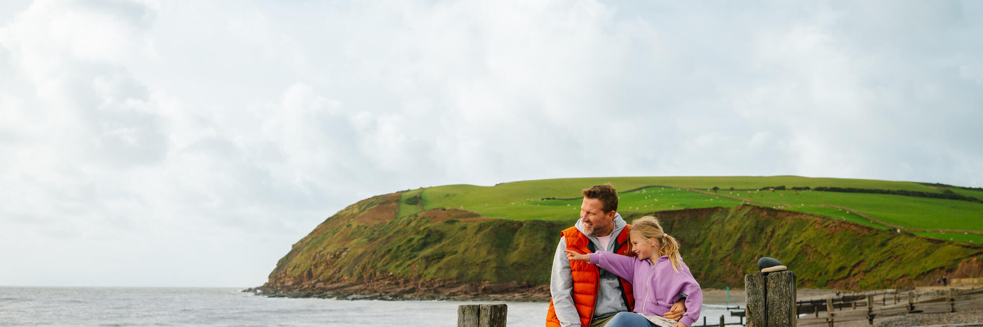 Father and daughter having fun on a beach