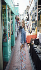 Woman walking down a pedestrian shopping street