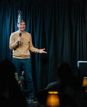 Man on stage performing a magic routine