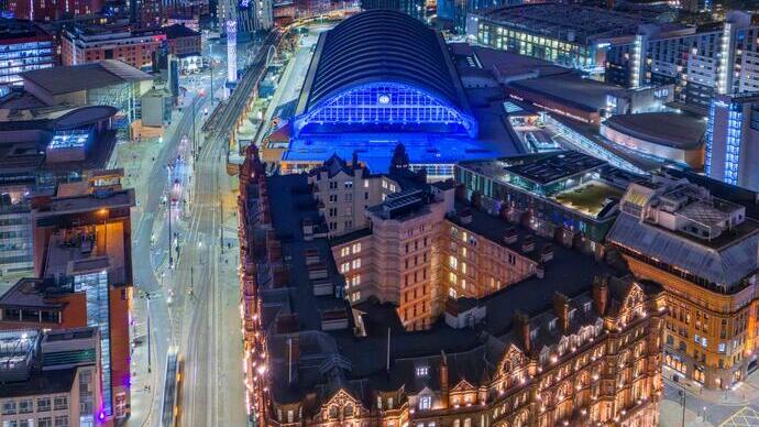 Aerial view of cityscape with commercial buildings lit up at night