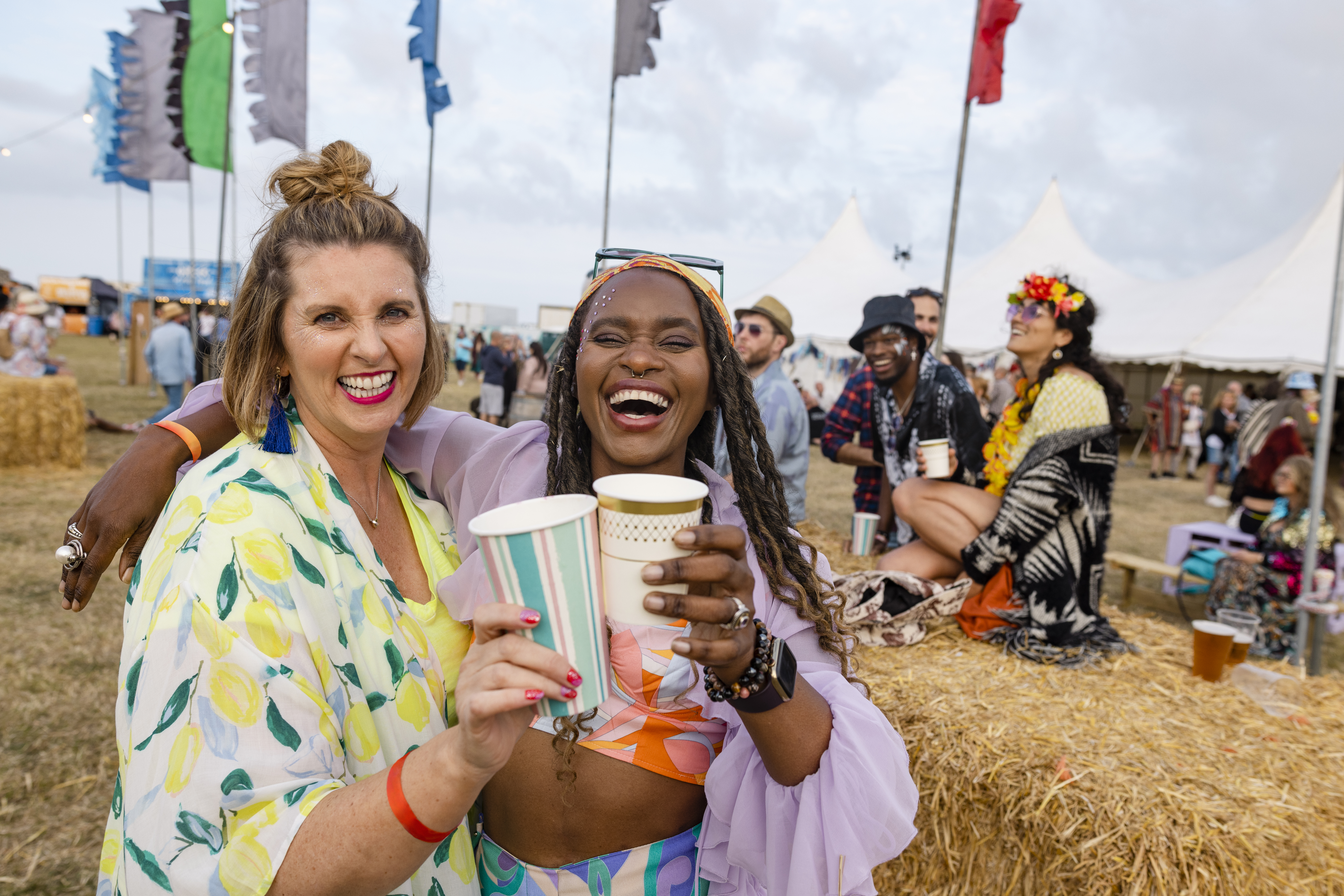 Two women having fun at a festival with friends