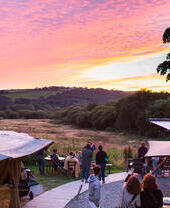 Groups of people watching the sunset at Fforest Farm