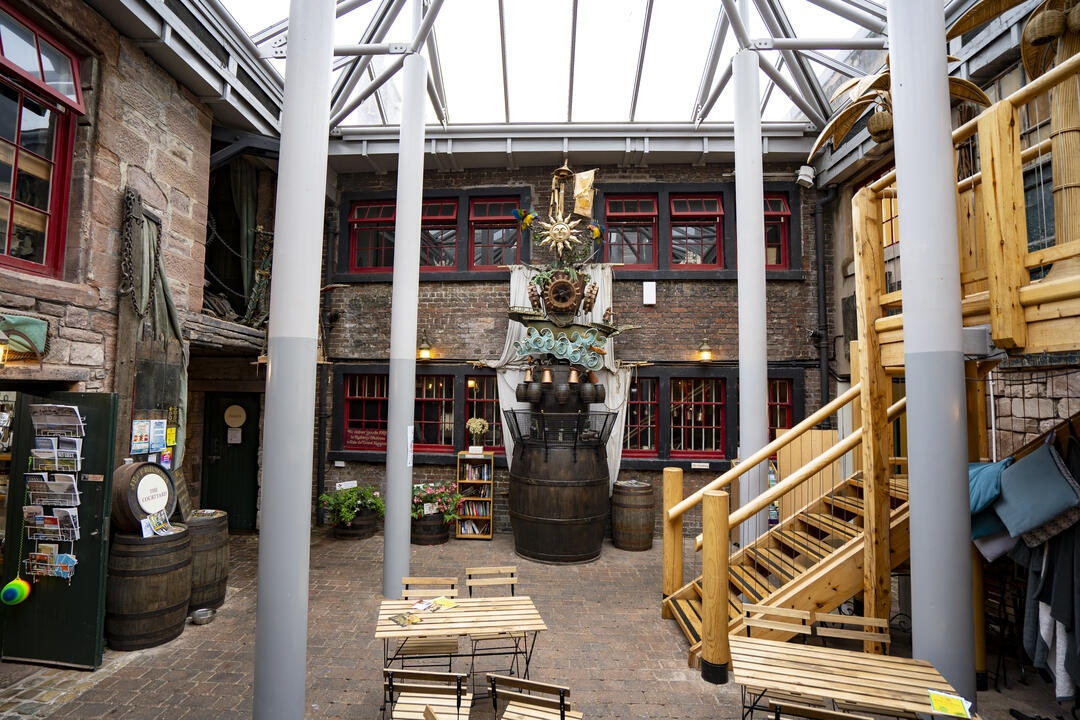 Chairs, tables and a sculpture at an internal courtyard