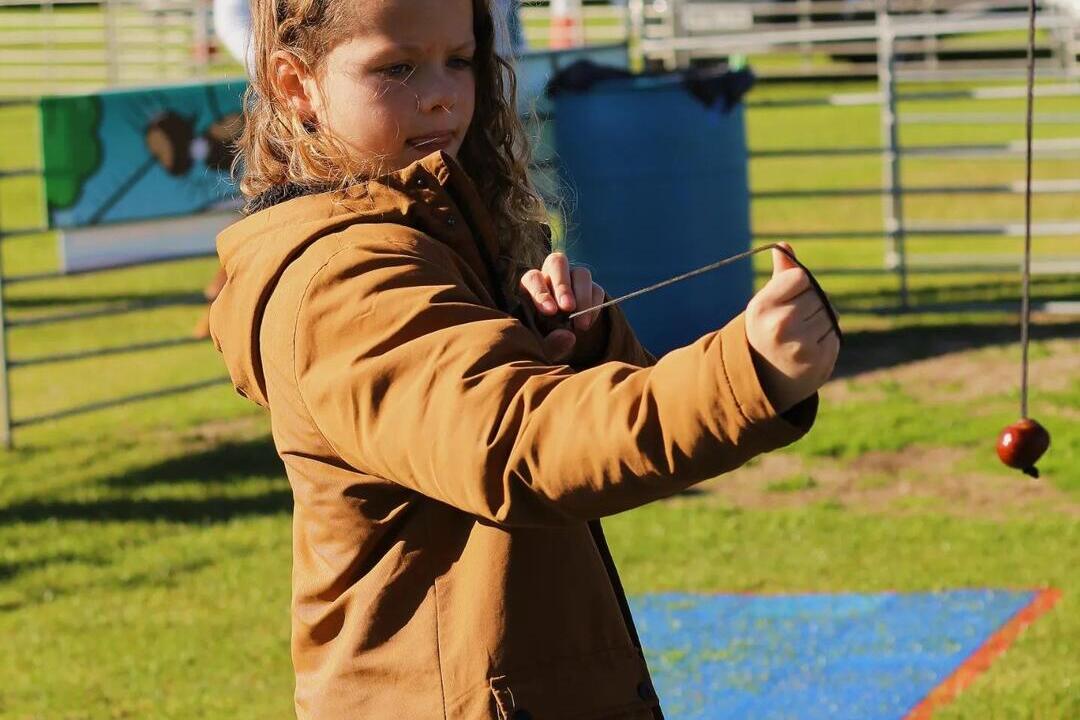 A child playing with a conker at the World Conker Championships in Northamptonshire