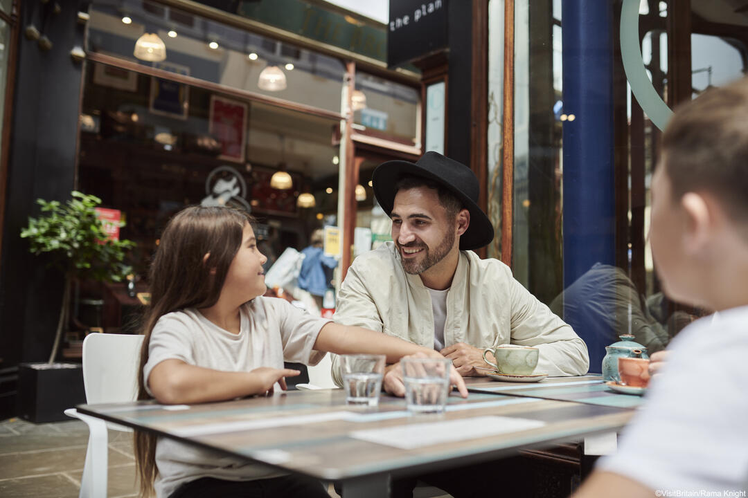 Family sitting down at a table in a restaurant