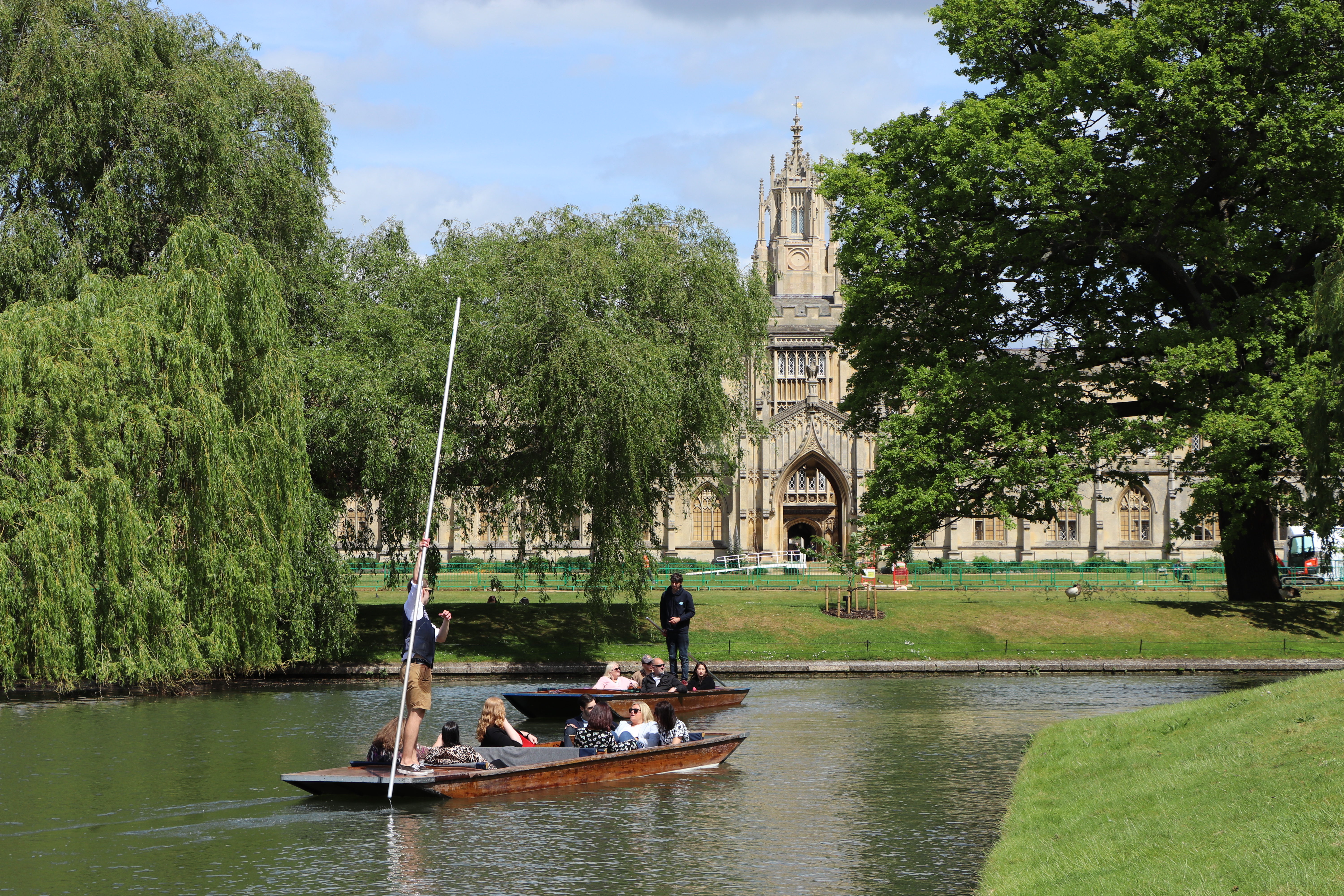 A punting tour passing a historic university building in Cambridge