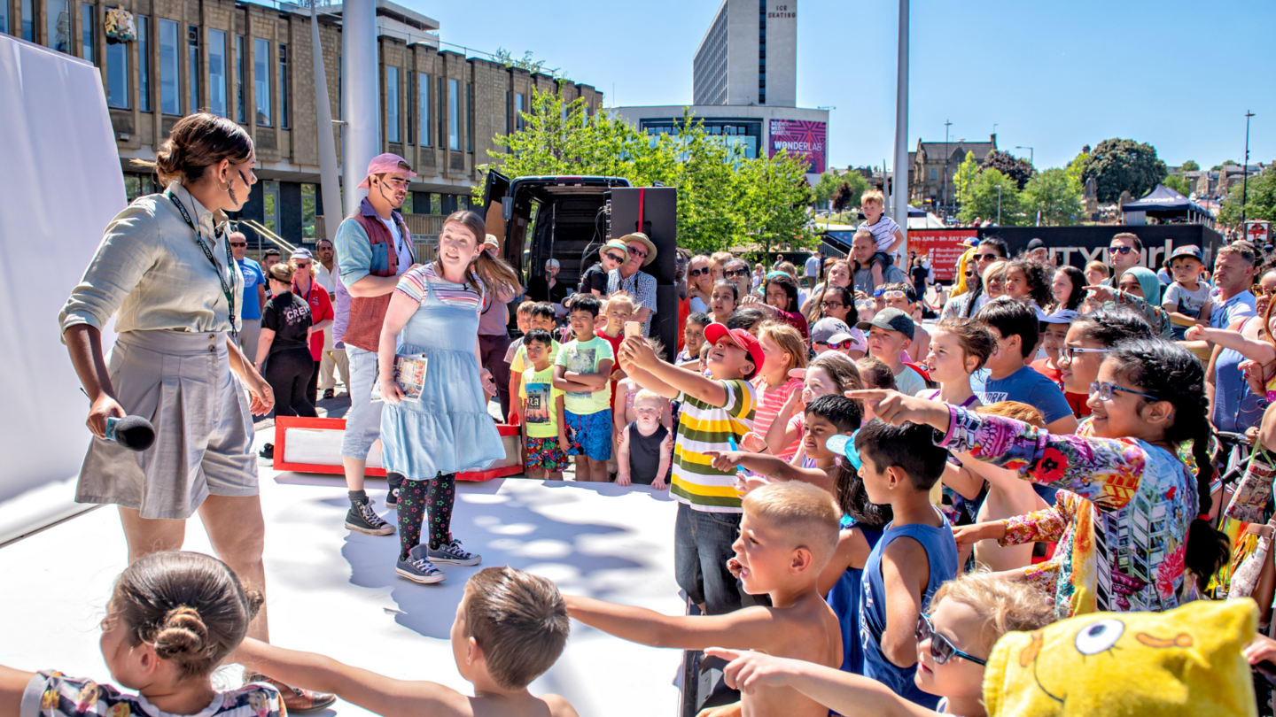 Performers on an outdoor stage at the Bradford Literature Festival