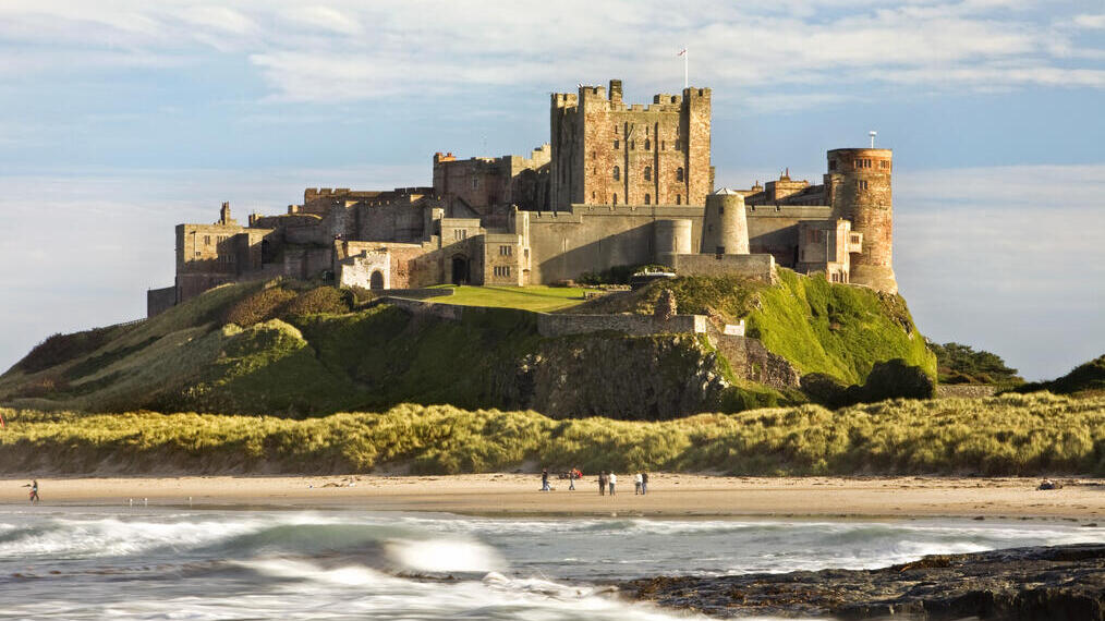 A castle on a cliff by a beach