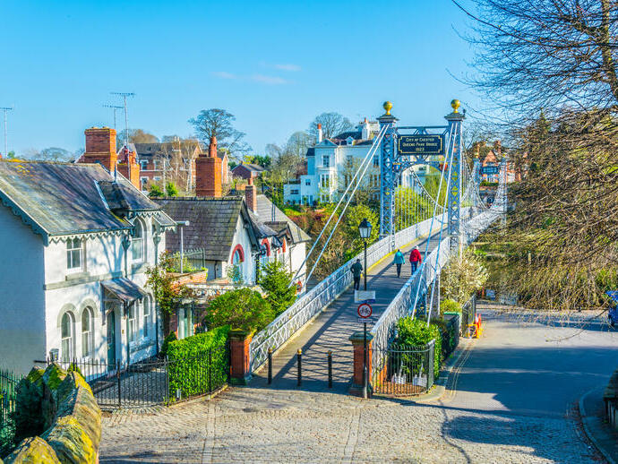 View of residential houses alongside a bridge over a river