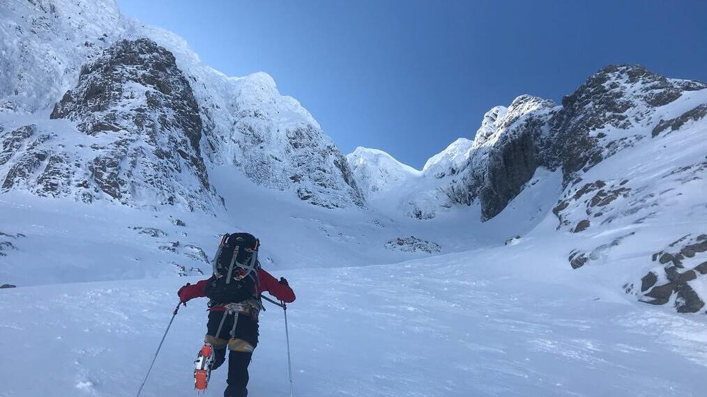 Person skiing in Cairngorms National Park, mountains in the background