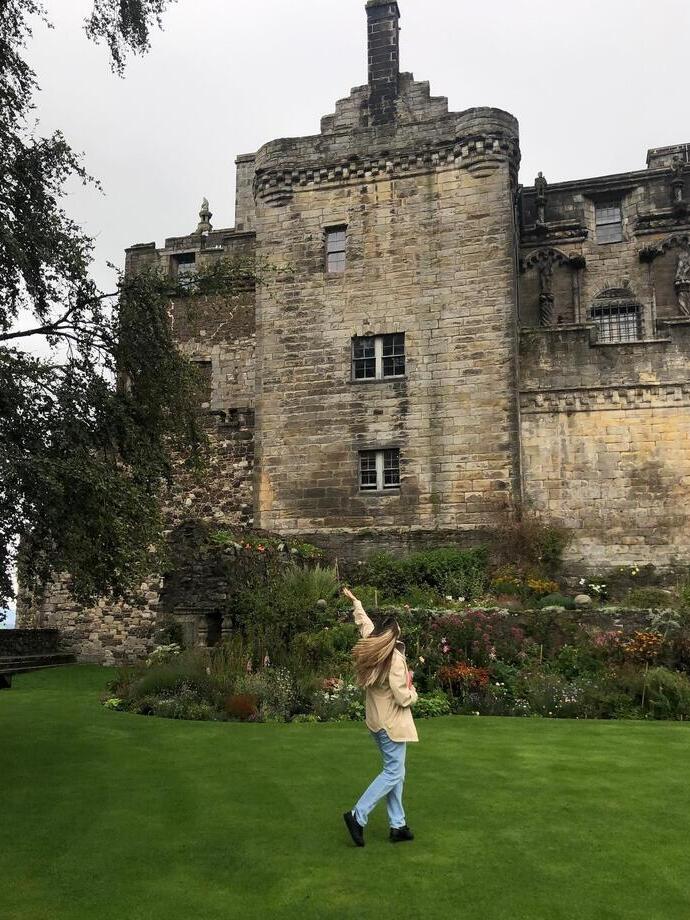 A woman posing in front of Stirling Castle, Scotland