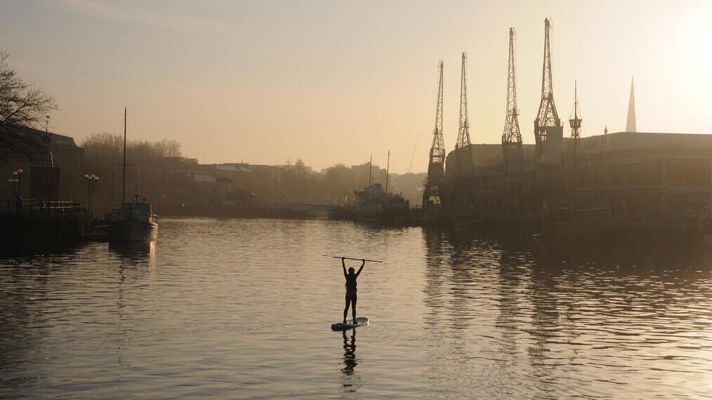 Una persona che fa paddleboarding nel mezzo del porto di Bristol