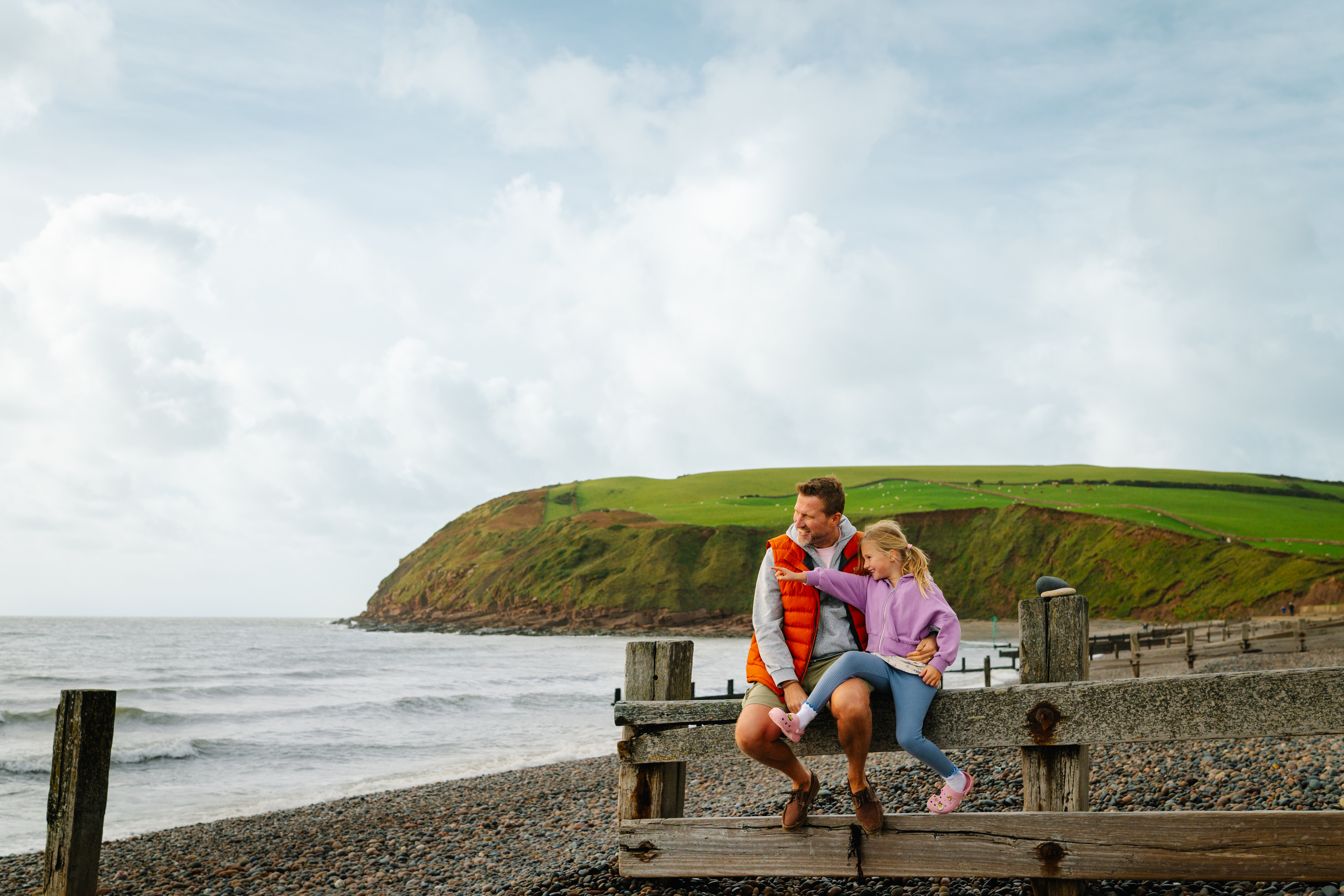 Father and daughter having fun on a beach