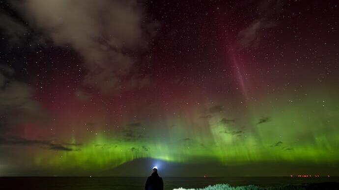 Man looking at northern lights at night