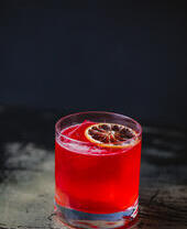 Glass with red coloured cocktail drink