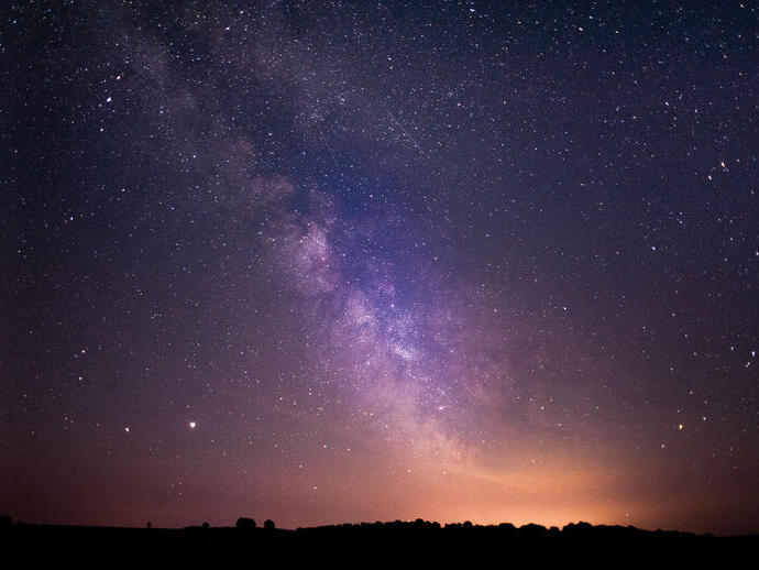 Stars and the Milky Way clearly visible in the night sky.