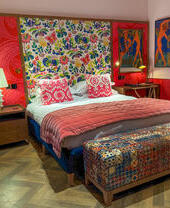 A vibrantly decorated bedroom in an upmarket hotel.