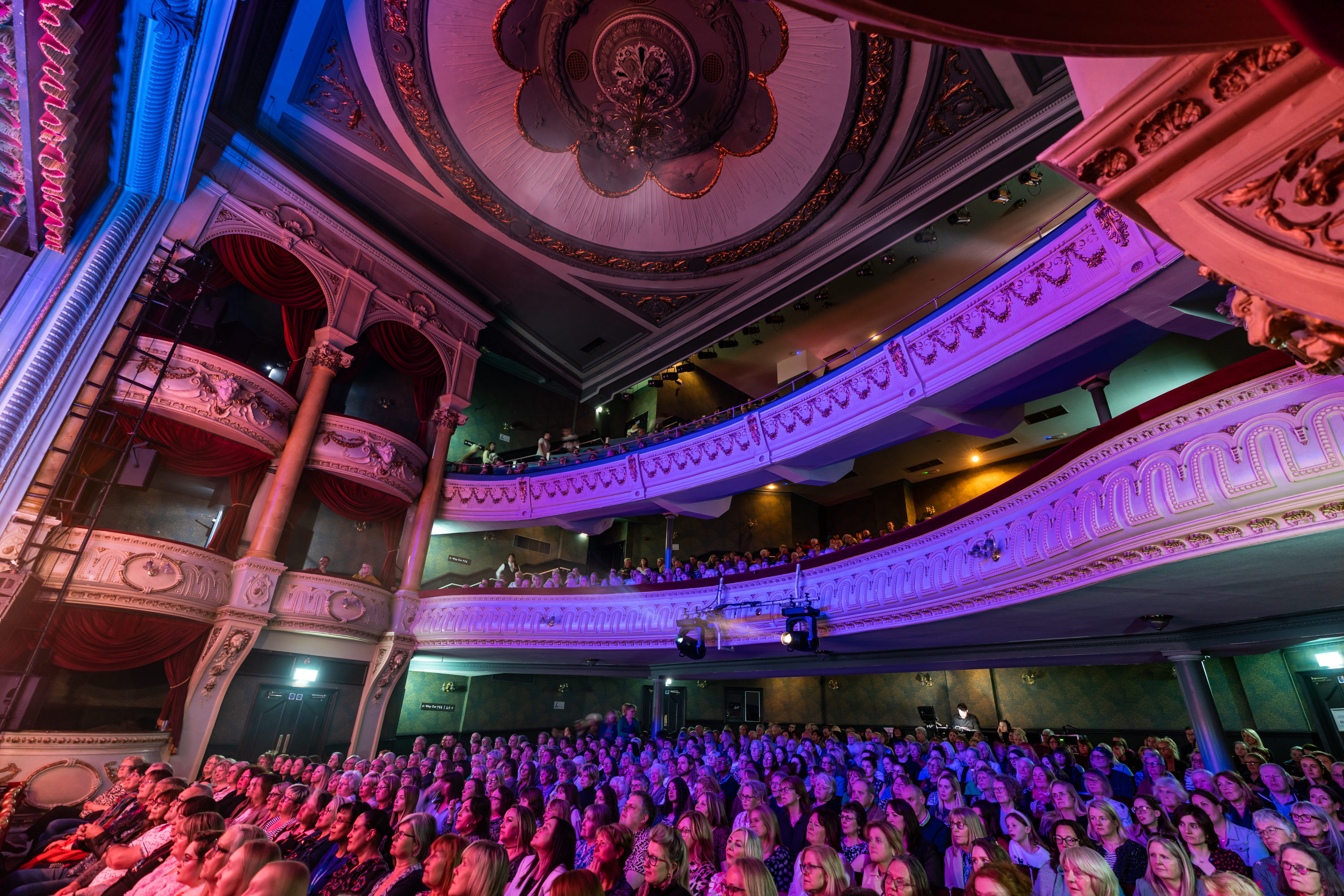 A crowd in the Grand Opera House York watching a performance