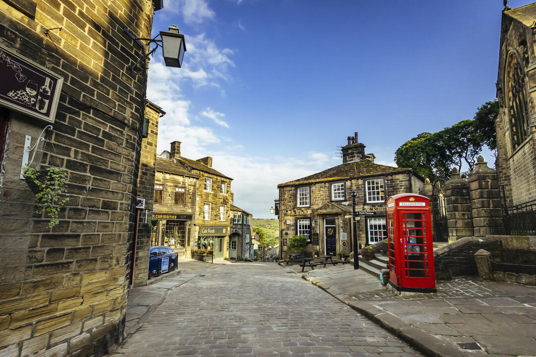 A view down a traditional cobbled street with a telephone box in view