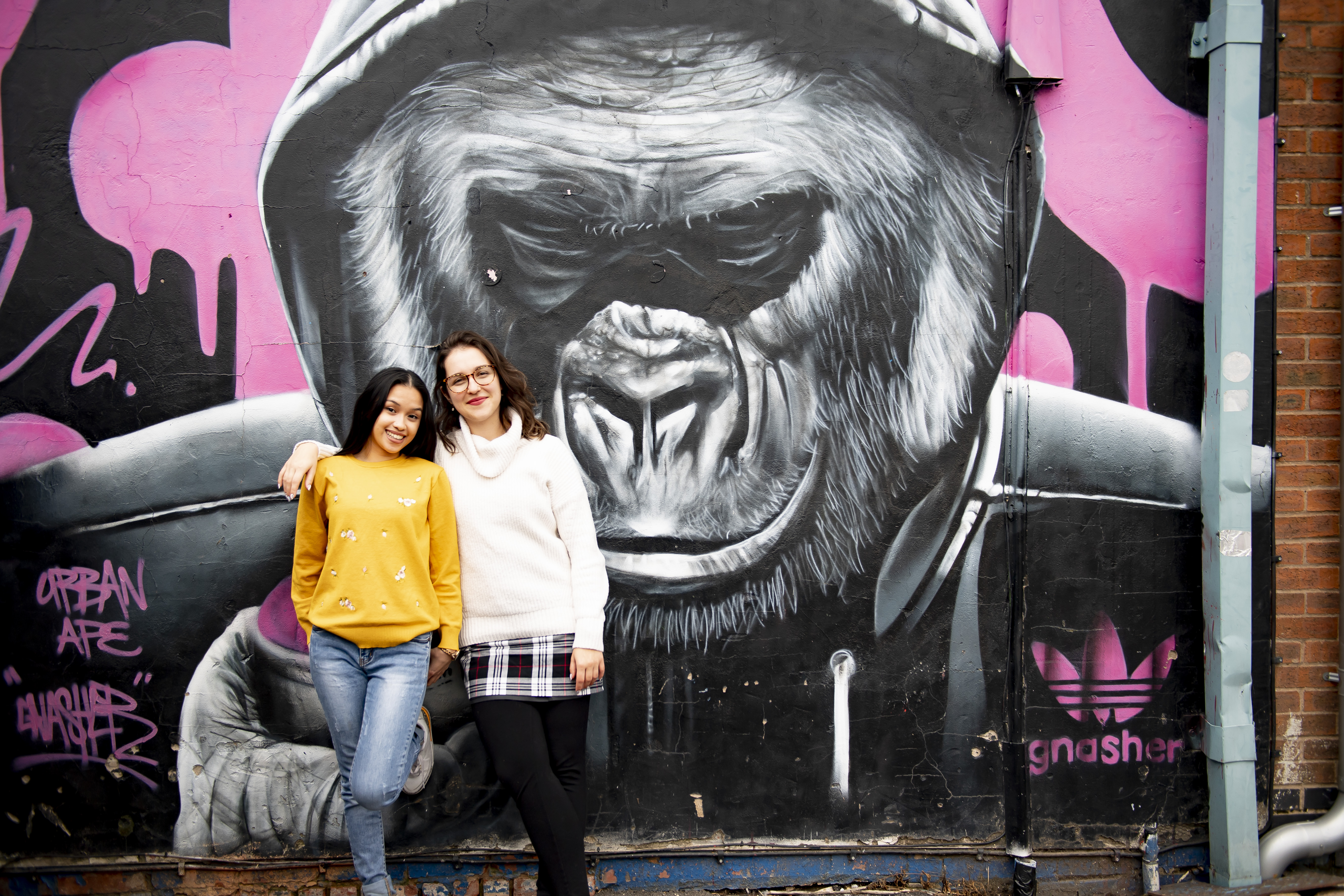 two people stand in front of Gorilla artwork by Gnasher