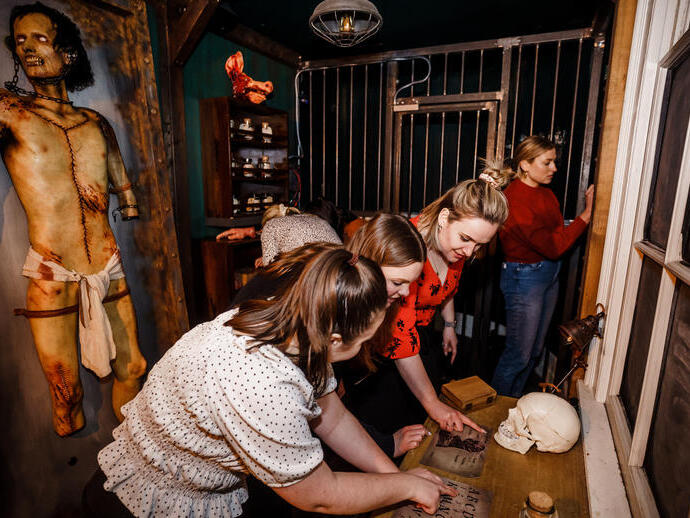 Five friends trying to work their way out of a small escape room