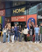 A group of people on a music themed tour of Manchester