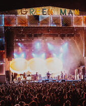 Crowd at a music festival in front of the stage at night