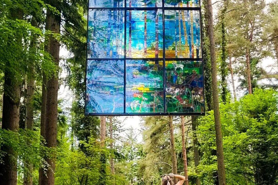 Large hanging stained glass window artwork of trees"Cathedral" by Kevin Atherton in The Forest of Dean
