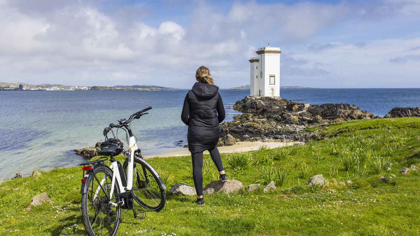A woman exploring the Isle of Islay via electric bike