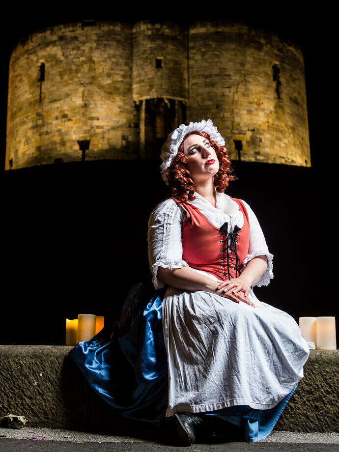 A performer in costume outside Cliffords Tower in York