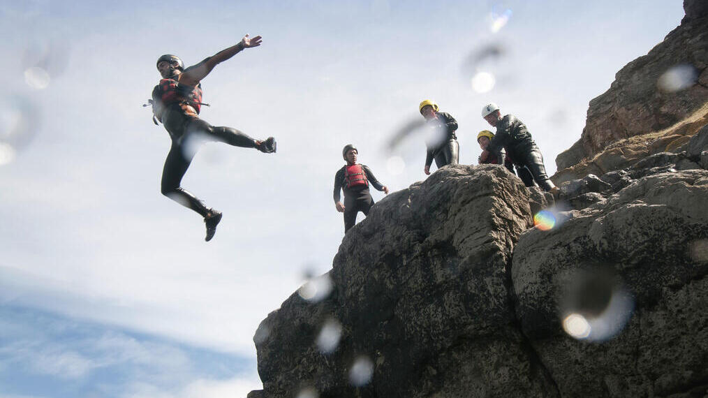One person leaping in mid air off the cliffs.