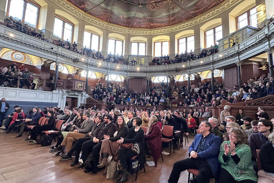 Crowds of people watching a talk on stage at Oxford Literary Festival