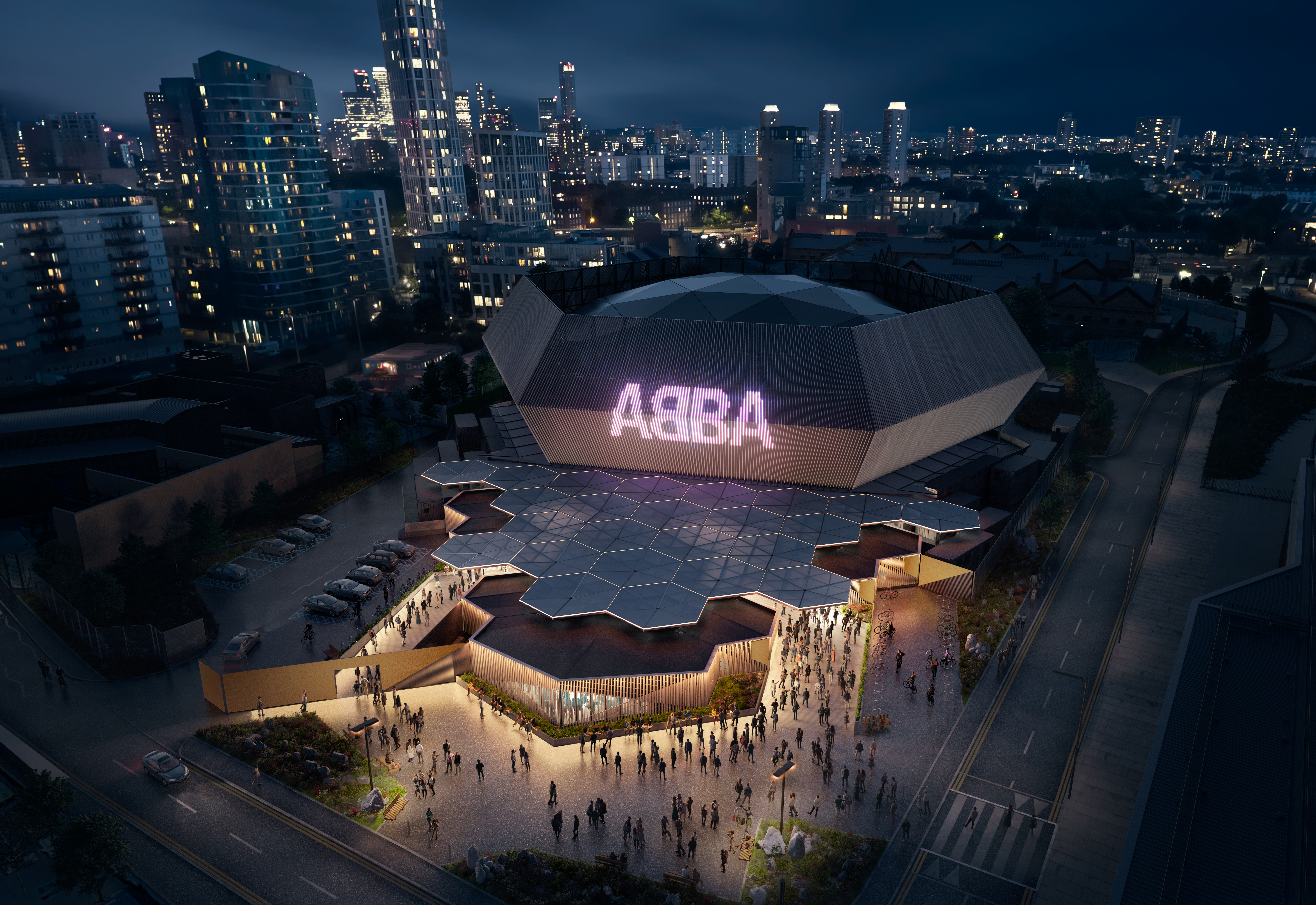 Aerial promotional image for ABBA Voyage of large venue at night with ABBA sign lit up and people at entrance