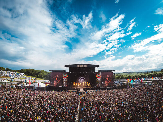 A large crowd watching a performance at Download Festival's main stage