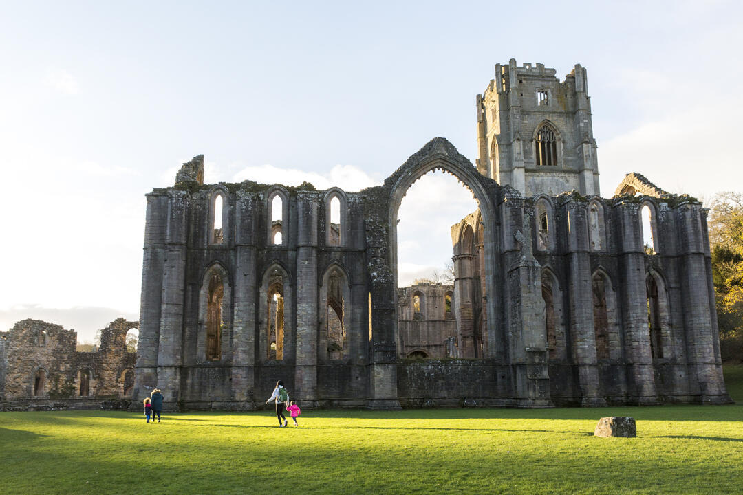 Visitors walking in the garden at Fountains Abbey and Studley Royal Water Garden, North Yorkshire