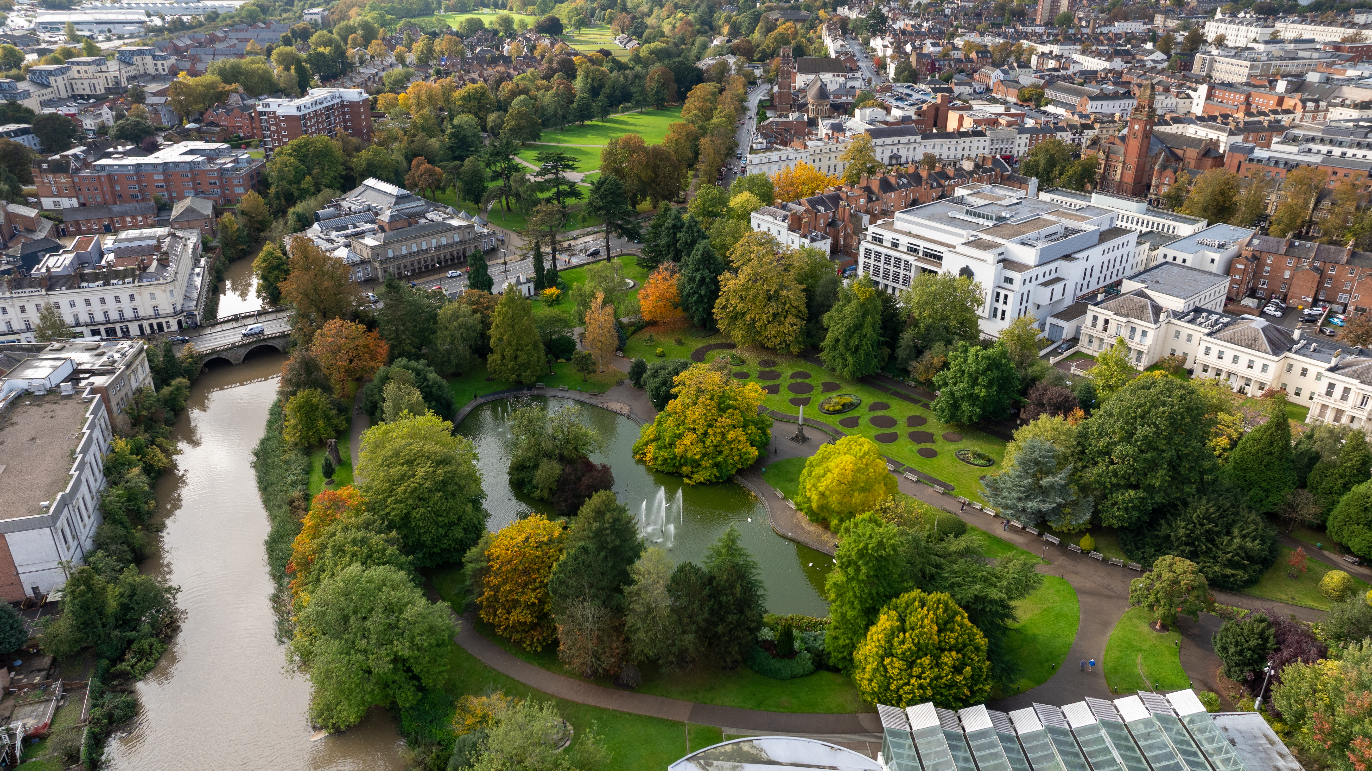 Aerial view of parks and gardens surrounded by trees with autumn foliage