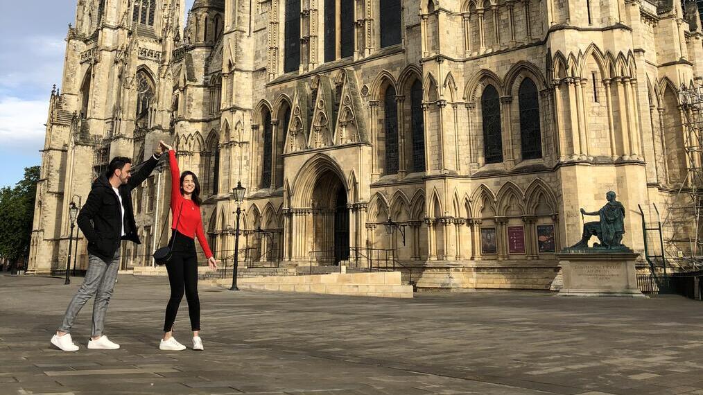 Man and woman dancing outside an historic building