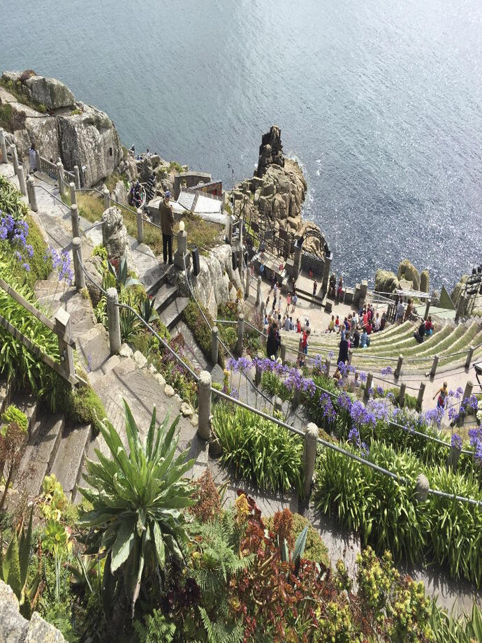 A stone theatre built into the cliff by the sea