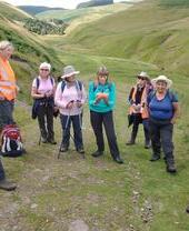 A group of people listening to a tour guide - OOT Walk, Bailiffgate Museum