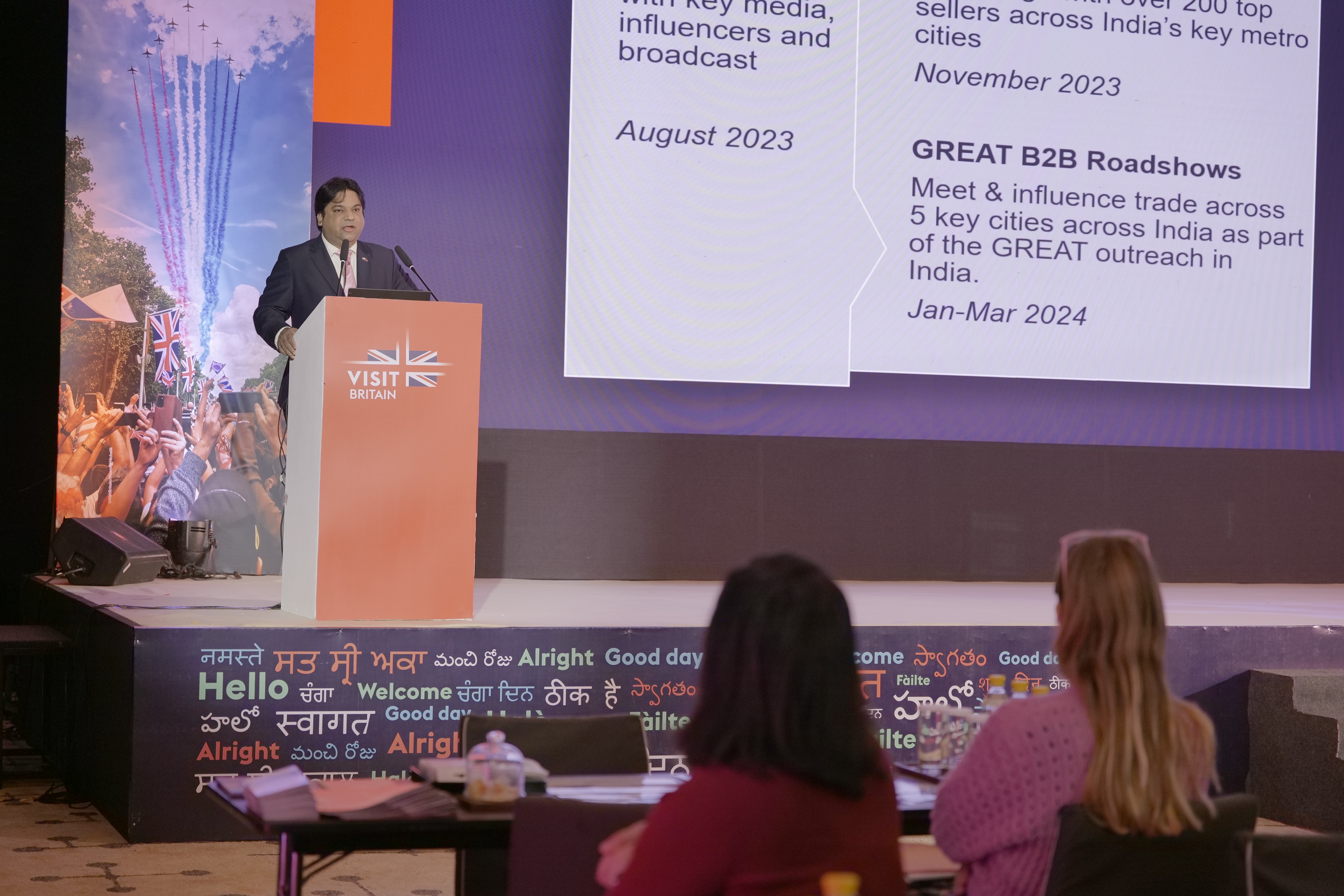 Man makes speech to delegates from podium at event