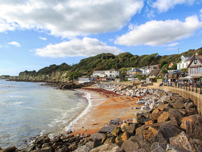 Coastline with sand and houses in a cove